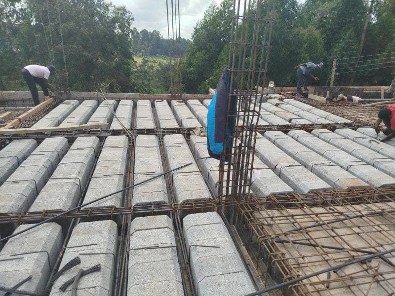 Block-and-beam suspended floor slab under construction, with tied steel reinforcement and column starter bars projecting upward